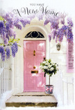 In this image, a serene and hopeful doorway scene unfolds, one that would feel perfectly at home in Morden's calm residential streets, perhaps near the riverside paths of Morden Hall Park or close to a leafy cul-de-sac. The front door is painted in a soft pink, its blush tone gentle yet uplifting against the smooth, whitewashed walls that frame it. A pale shutter beside the door, brushed with the same pastel hue, creates a subtle symmetry, lending the entrance an almost storybook charm. Above, wisteria spills over in abundant clusters of lavender and pale lilac, its dangling flowers forming a natural canopy that softens the lines of the building. The light appears to be that of late afternoon, filtering through the wisteria and leaving dappled shadows that ripple across the plaster and door panels. At the base of this dreamy doorway sits a simple grey metal bucket, turned into a work of floral art by a florist's careful hands. It is filled with creamy white and soft ivory roses, each bloom lush and velvety, layered with petals that spiral out from gentle centres. Threads of soft green foliage peek between the roses, adding depth, movement, and the suggestion of refreshing fragrance. A delicate pink ribbon is tied around the bucket, its satin bow relaxed yet precise, echoing the colour of the door and completing the pastel story. The atmosphere is tender, almost like a visual exhale-a set of new home flowers that could be delivered on move-in day, turning an ordinary Morden threshold into an intimate symbol of welcome, optimism, and the promise of cherished memories yet to come.